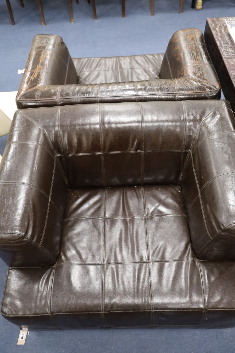 A pair of Andrew Martin brown leather armchairs, width 100cm depth 84cm height 70cm